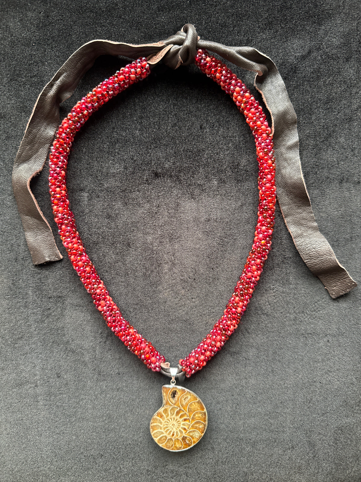 #414  ammonite fossil pendant and red glass beaded necklace 