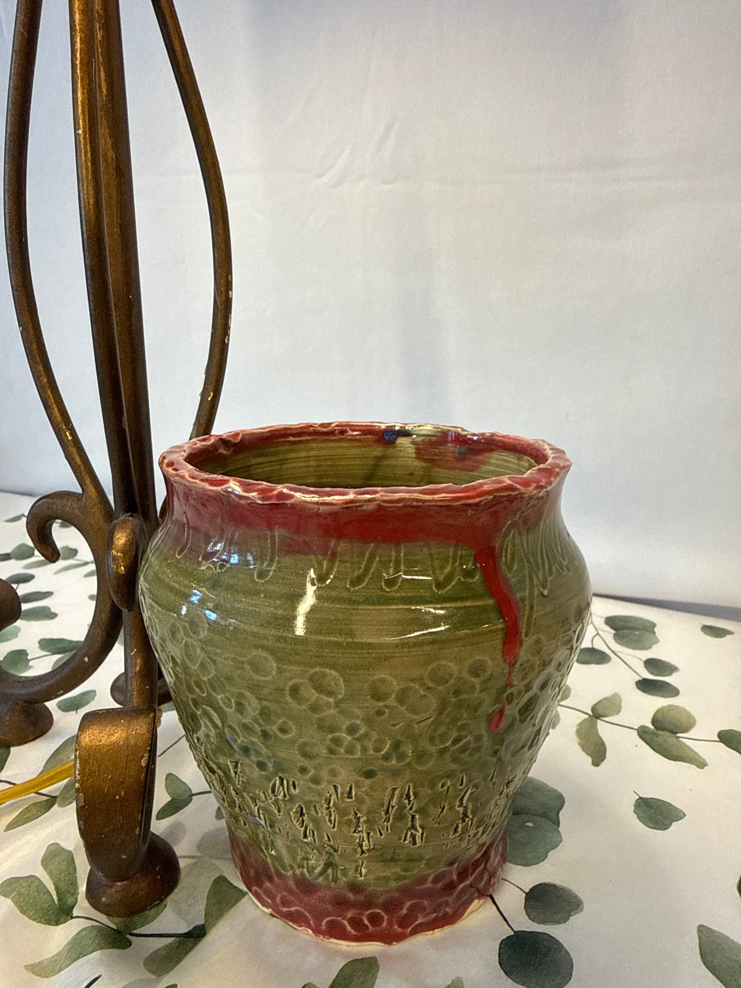 Green pot with red trim, top and bottom ￼
