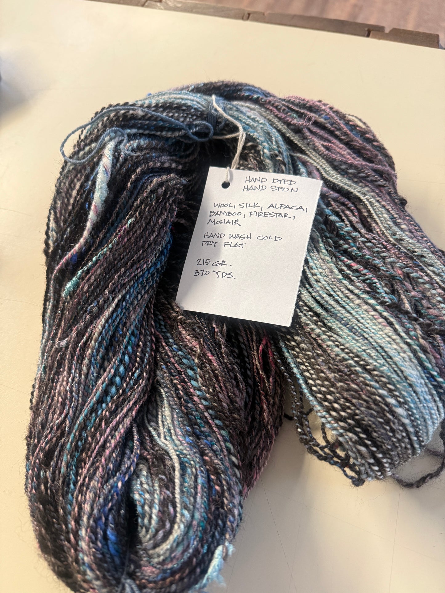 Yarn 215 GR. 370 YDS black, blue, mauve hues